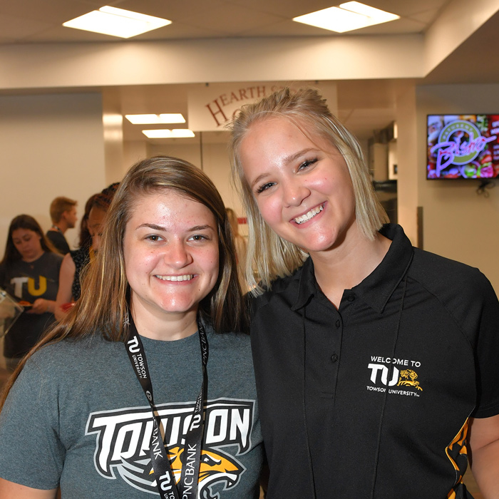 Orientation leader smiling with a student